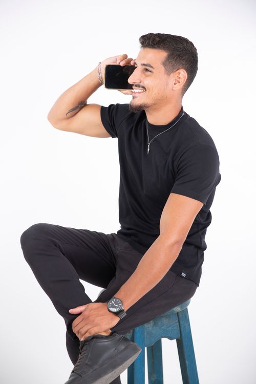 free bangla online chat – young man smiling while chatting on smartphone
