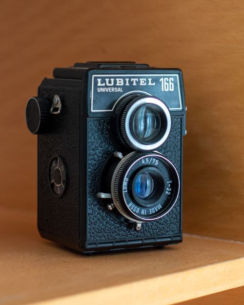 Free Vintage Lubitel 166 Universal camera displayed on a wooden shelf, showcasing retro design. Stock Photo