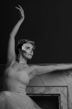 Striking black and white portrait of a ballet dancer with floral face decoration, exuding grace and elegance.