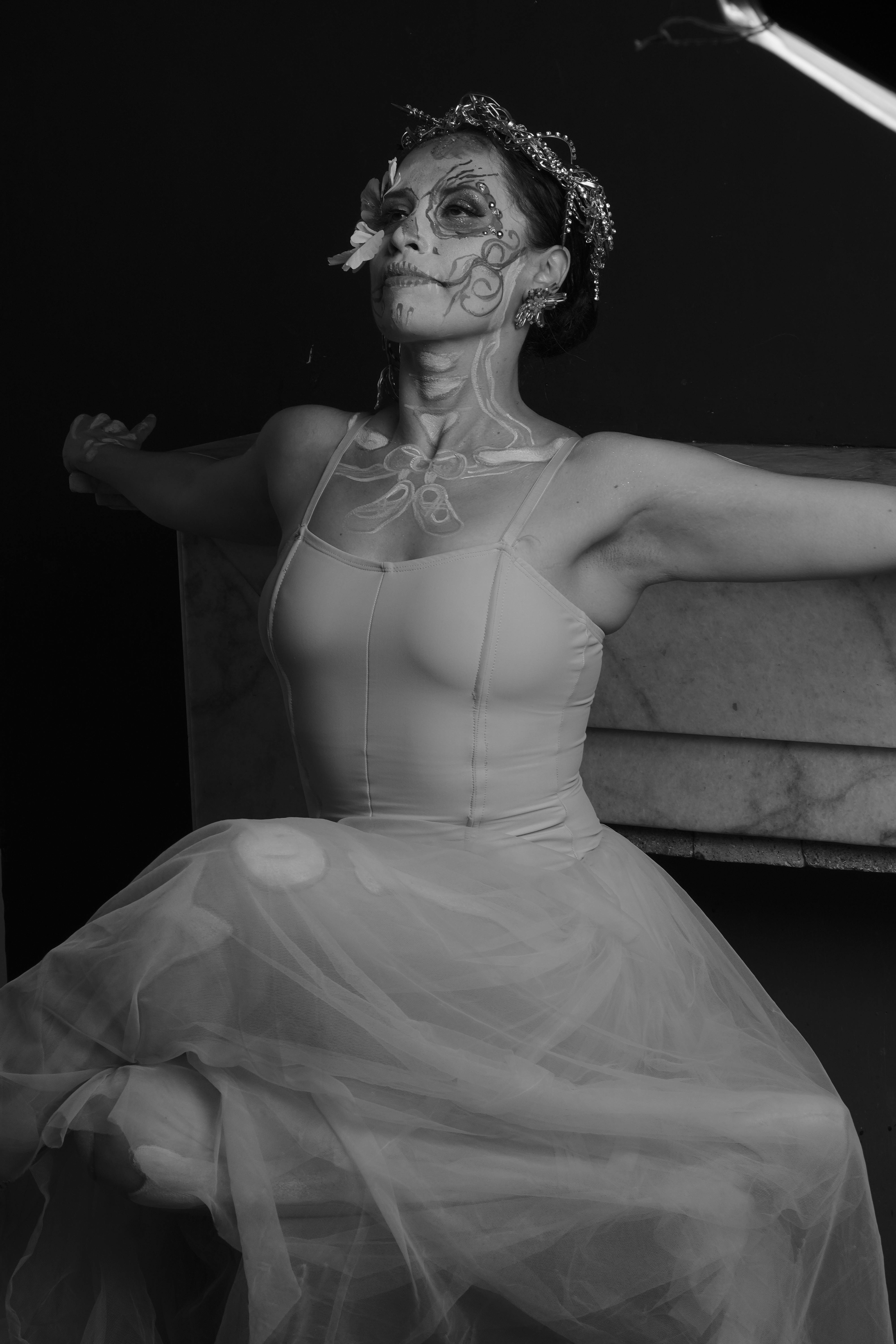 Free Elegant ballerina with face paint posed in a dramatic black and white light. Stock Photo