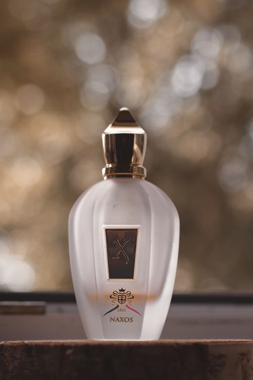 Free Elegant Xerjoff Naxos perfume bottle captured with a soft bokeh background in Berlin. Stock Photo