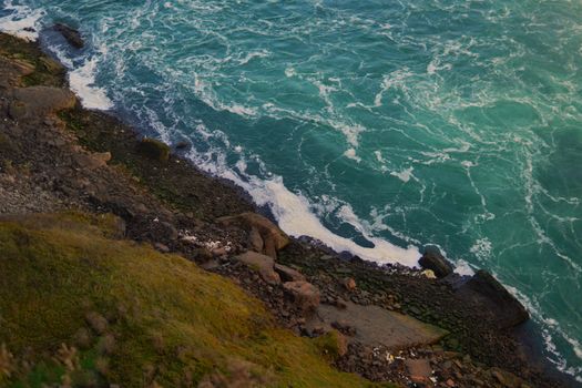 A breathtaking aerial view of Niagara Falls shoreline with turquoise waters and rugged rocks.