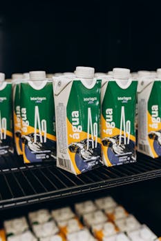 Close-up of packaged water bottles arranged on a shelf, highlighting branding.
