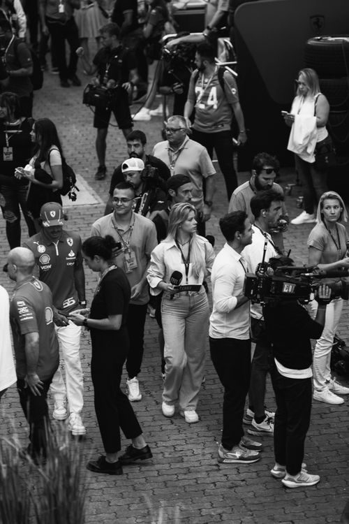 Free Black and white image of a bustling outdoor event with reporters and camera crews. Stock Photo