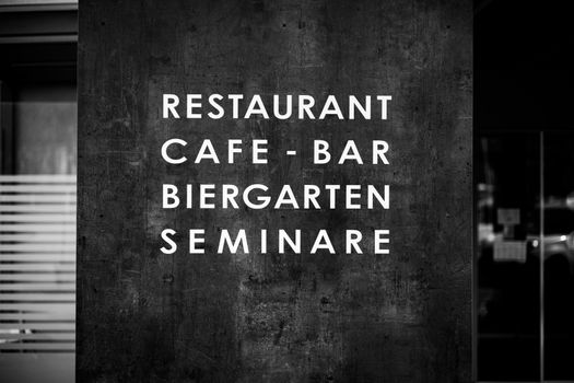 Stylish black and white shot of a restaurant sign in Kapfenberg, Austria.