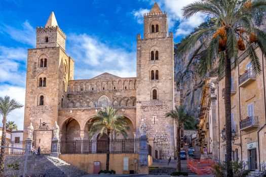Stunning view of the historic Cefalù Cathedral in Sicily, Italy, under a bright blue sky.