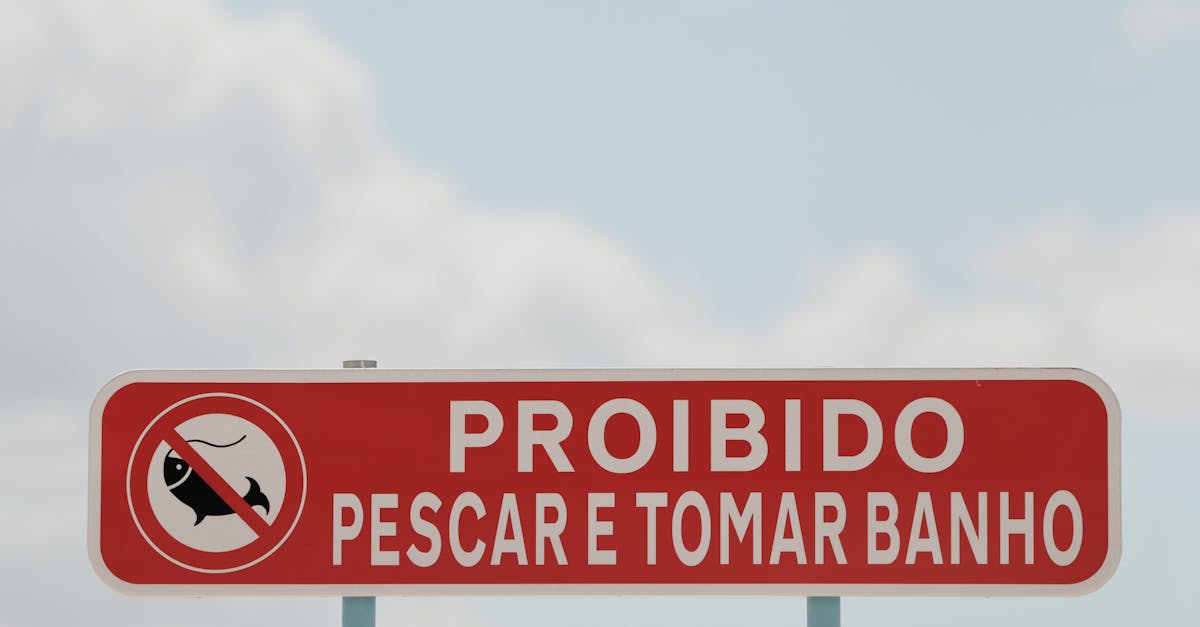 Red prohibition sign in Lisbon, Portugal forbidding fishing and bathing.