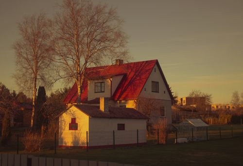 Free Warm sunset light on a cozy rural house in Estonia, capturing an autumnal mood. Stock Photo