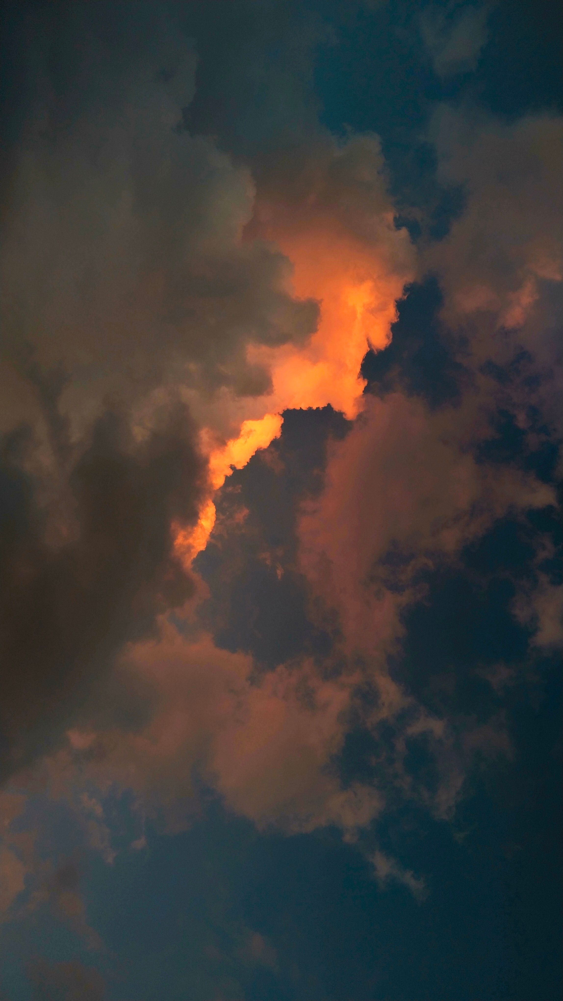 Capture of a dramatic sky with glowing clouds at sunset, creating a moody atmosphere.