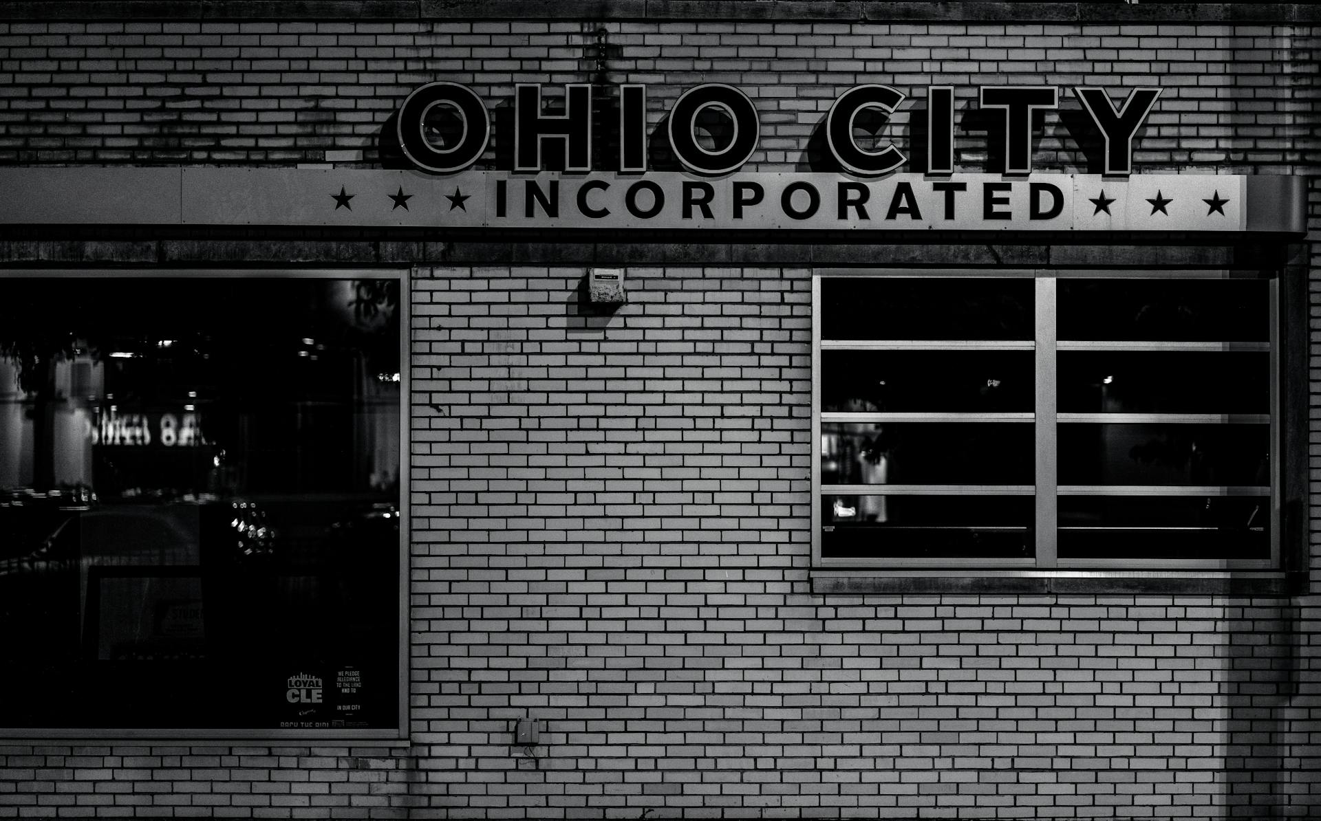 Black and white image of Ohio City's famous building façade at night highlighting urban architecture.