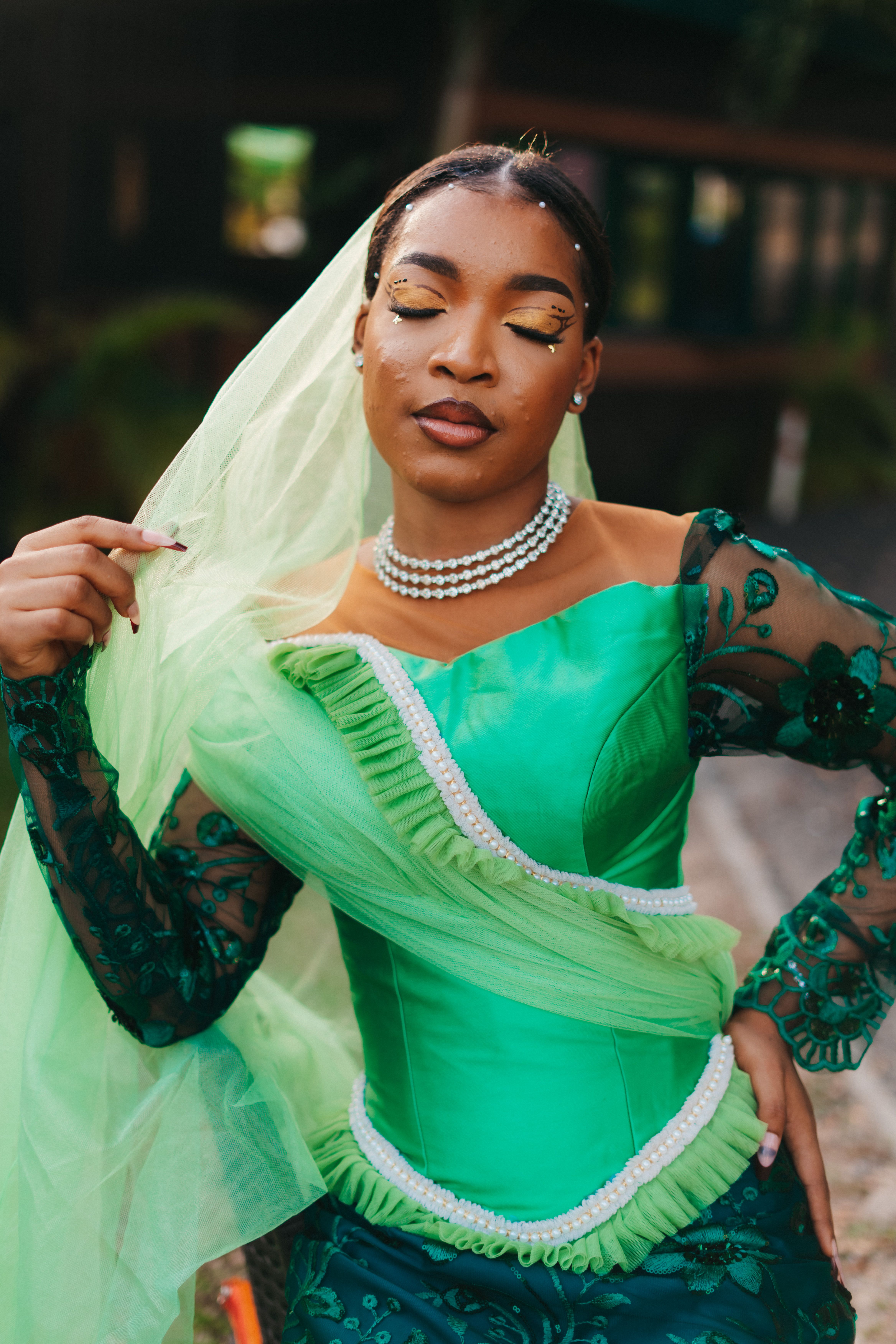 Elegant Nigerian bridal fashion with a vibrant green dress, showcasing cultural beauty and style.