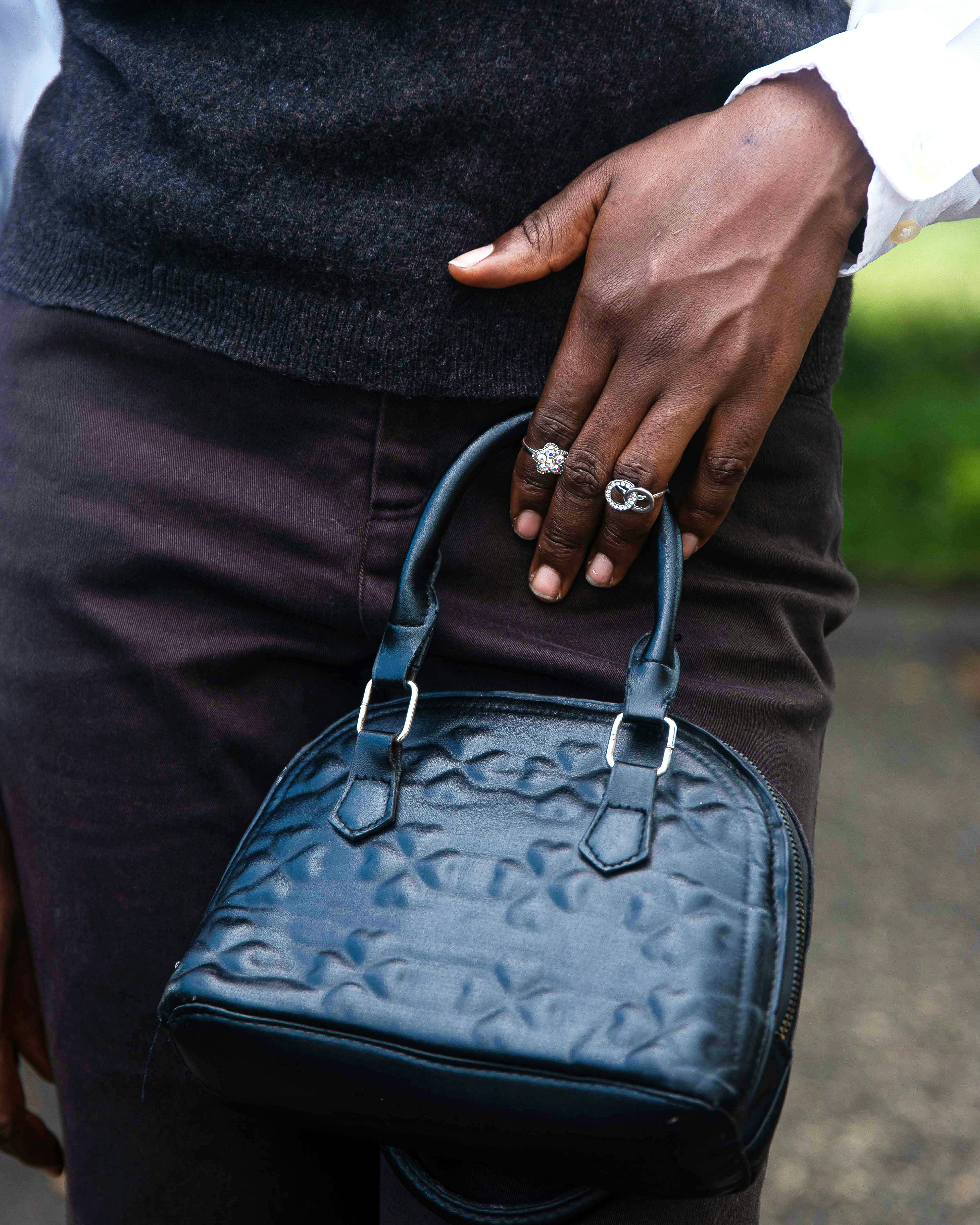 Stylish Handbag with Rings on Hand Outdoors · Free Stock Photo