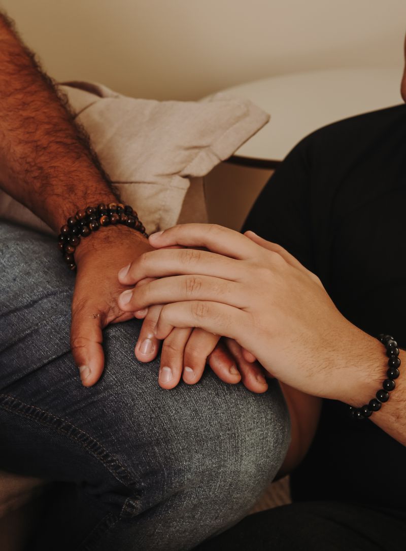 Close-up of two hands holding, symbolizing comfort and connection