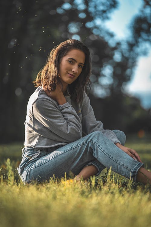 Photo Of Woman Sitting On Grass