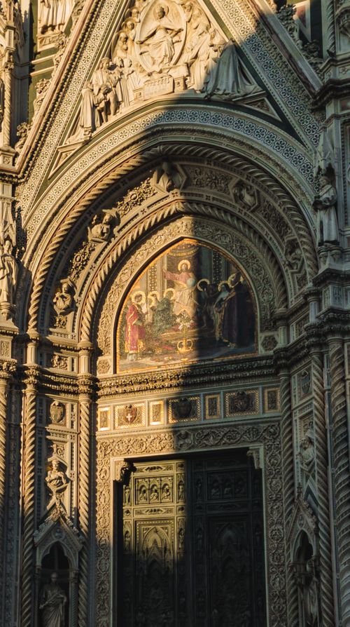 Free Close-up of the detailed facade of Florence Cathedral at sunset, showcasing Gothic artistry. Stock Photo
