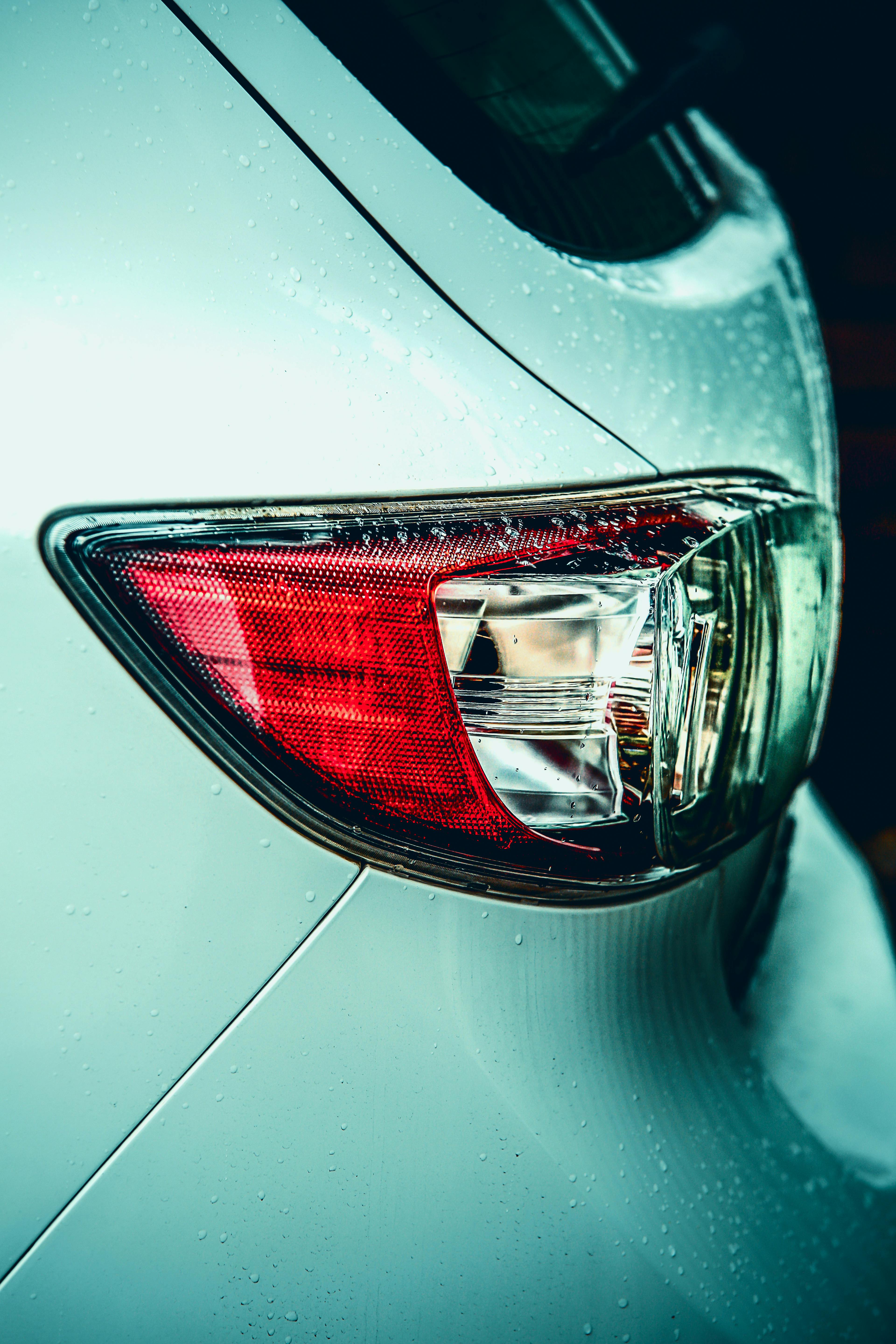Detailed shot of a car's taillight with raindrops in Huddersfield, UK.