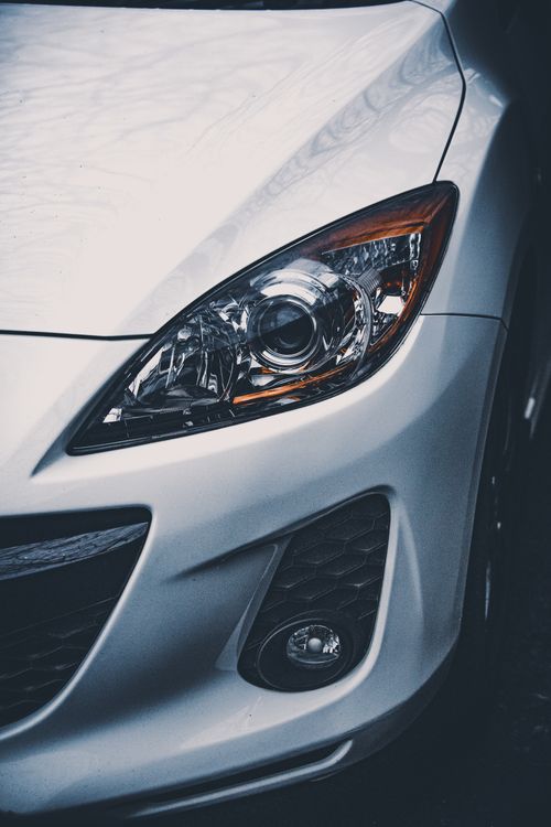 Free Detailed close-up of a car's front headlight in Huddersfield, UK. Stock Photo