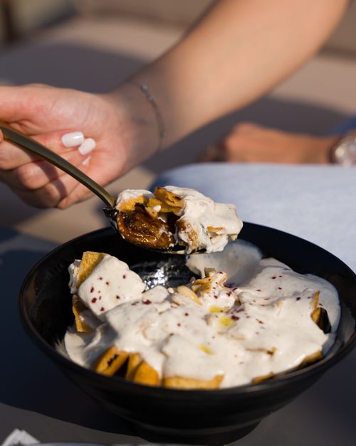 Free Close-up of nachos drizzled with a rich, creamy sauce, perfect for a delicious snack. Stock Photo