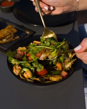 Colorful Mediterranean salad with toasted pita on a sunny day.