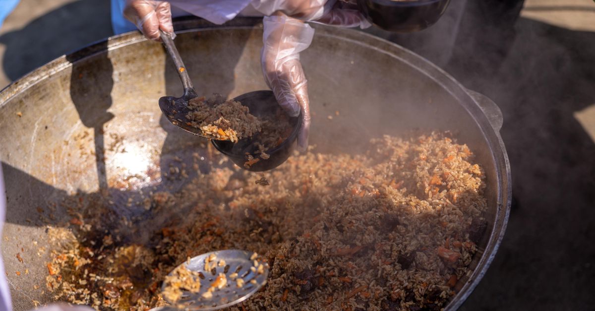 Steaming pots of jollof rice and fried plantains at a community gathering in Ho Ghana