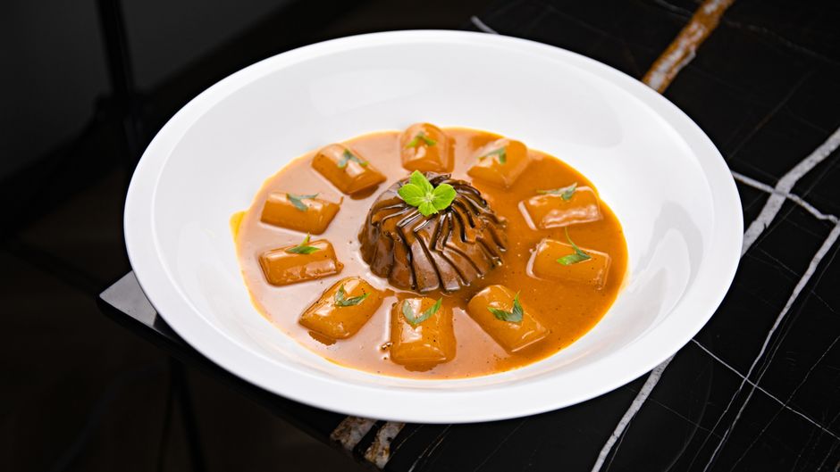 A dense, spiced baked pudding made from fully ripe Hachiya persimmon pulp, a classic fall dessert similar in spirit to a steamed date pudding.