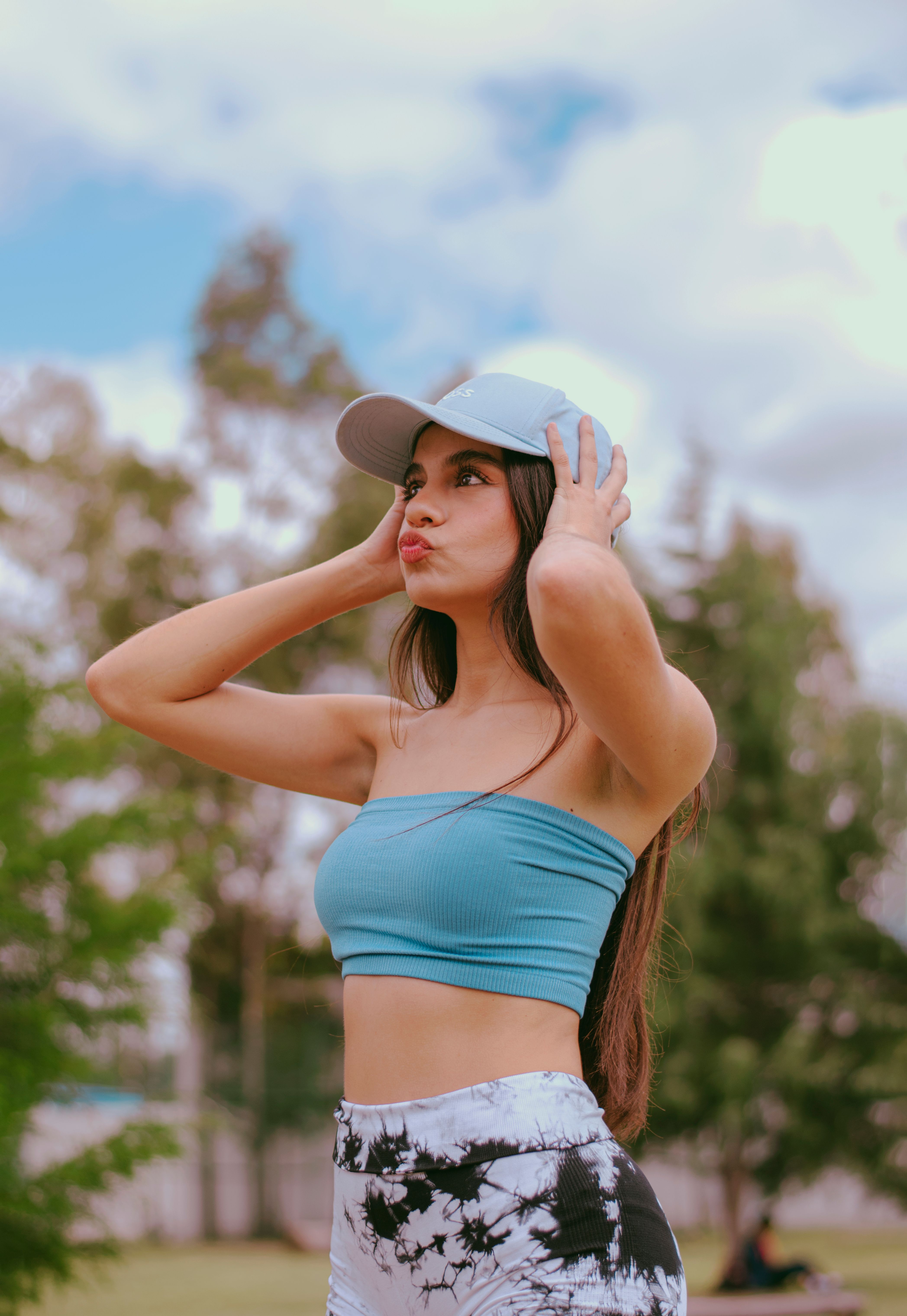 Young Woman Posing Outdoors in Summer Attire · Free Stock Photo