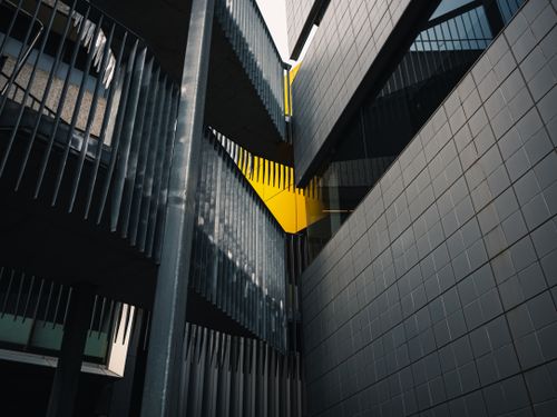 Free Abstract view of modern architecture highlighting geometric shapes and dramatic lighting. Stock Photo