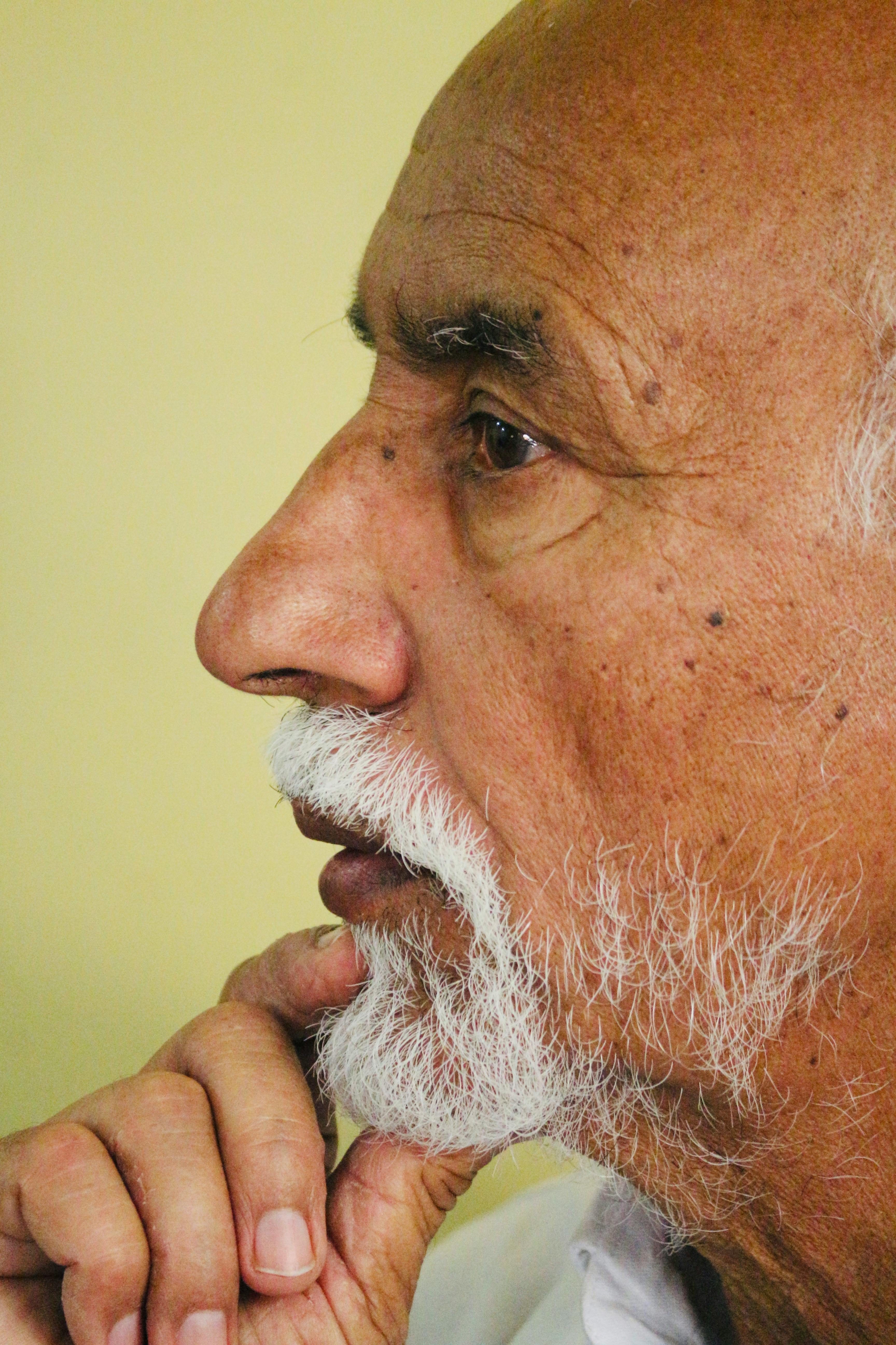 Side profile of a senior man in deep thought, highlighting wisdom and contemplation.
