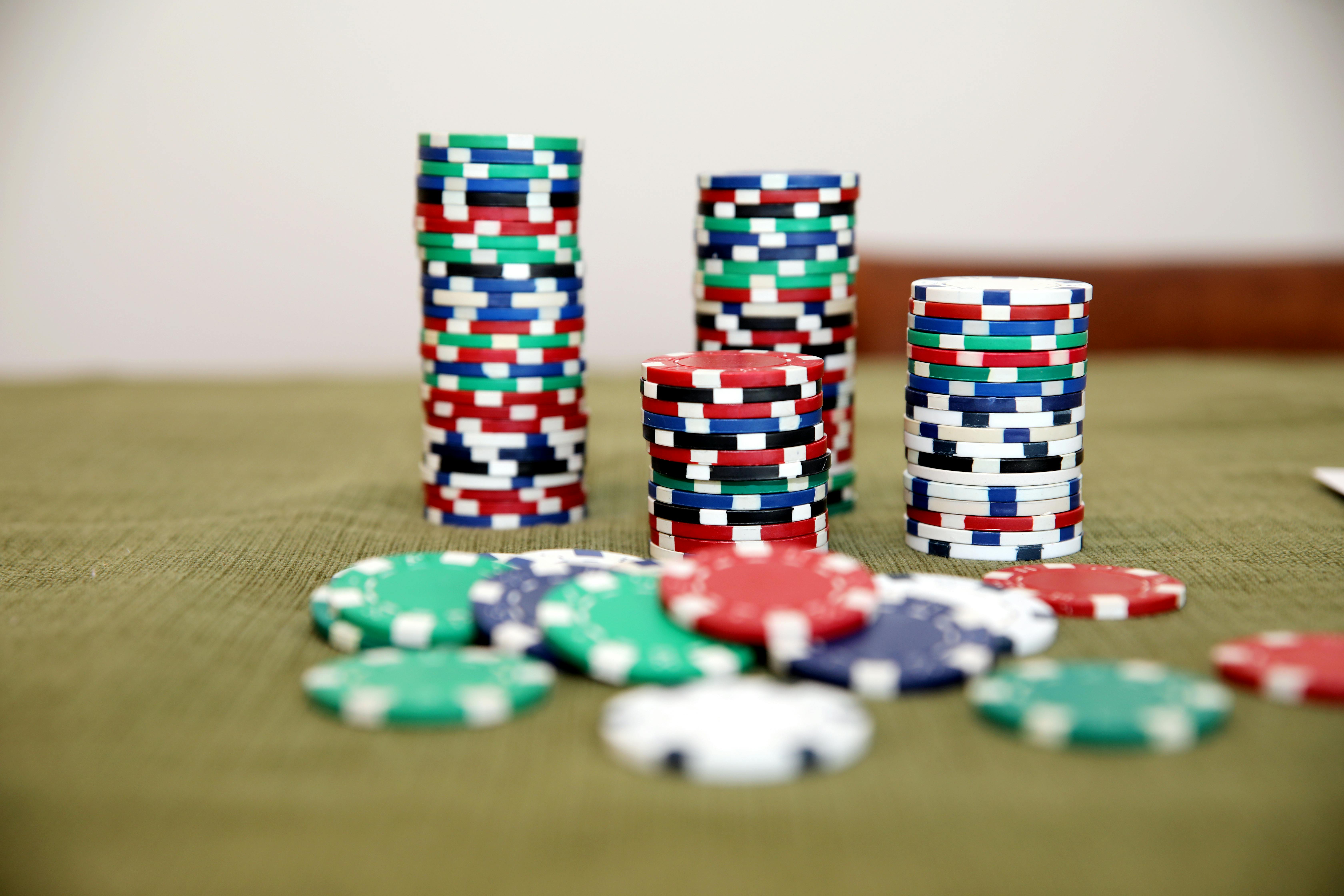 colorful poker chips stacked on green cloth