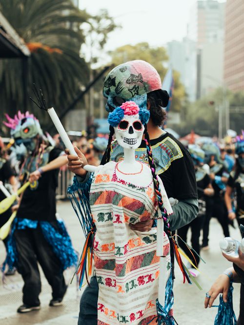 Free Colorful Día de los Muertos parade with traditional costumes in Mexico City's streets. Stock Photo