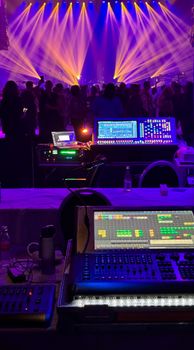 Dynamic concert scene with colorful stage lights and sound equipment.