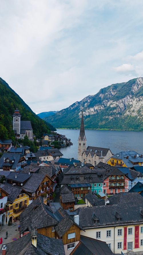 Free Picturesque shot of Hallstatt's colorful buildings with a scenic lake and mountains. Stock Photo