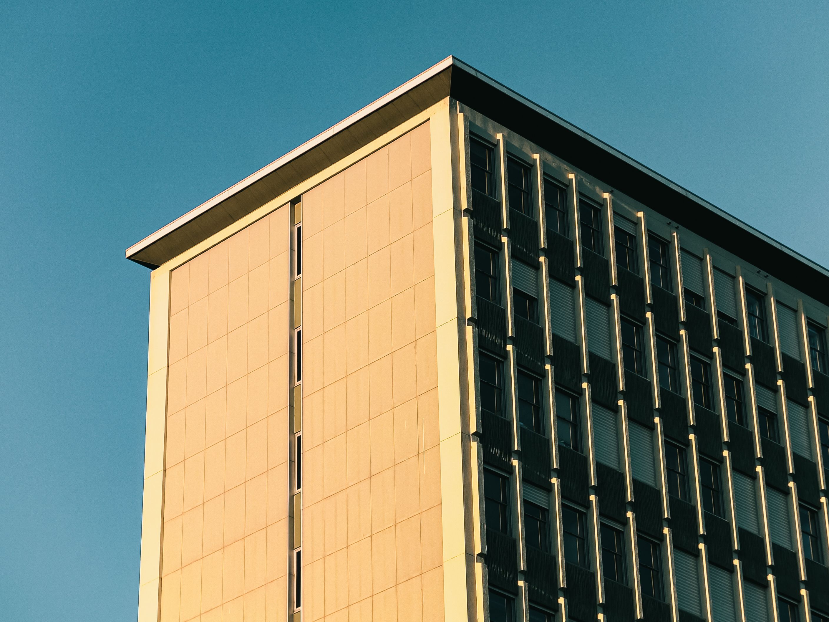 Modern Urban Building Against Clear Blue Sky · Free Stock Photo