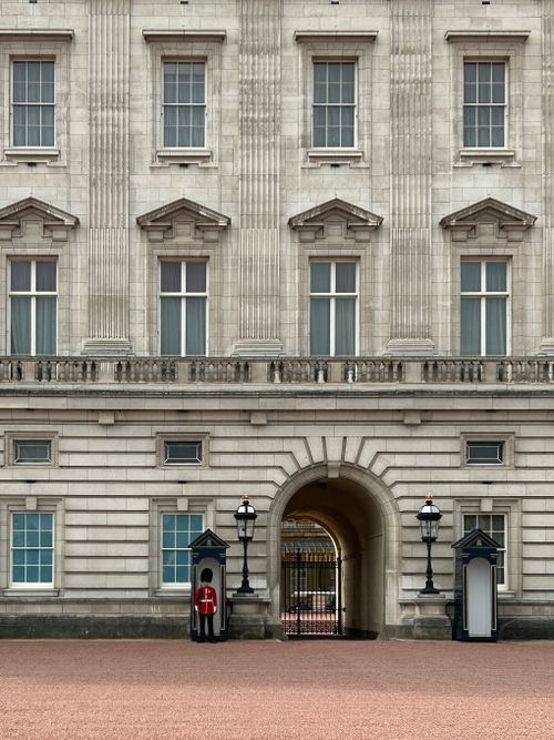 Free Buckingham Palace exterior with a royal guard on duty in London, UK. Stock Photo