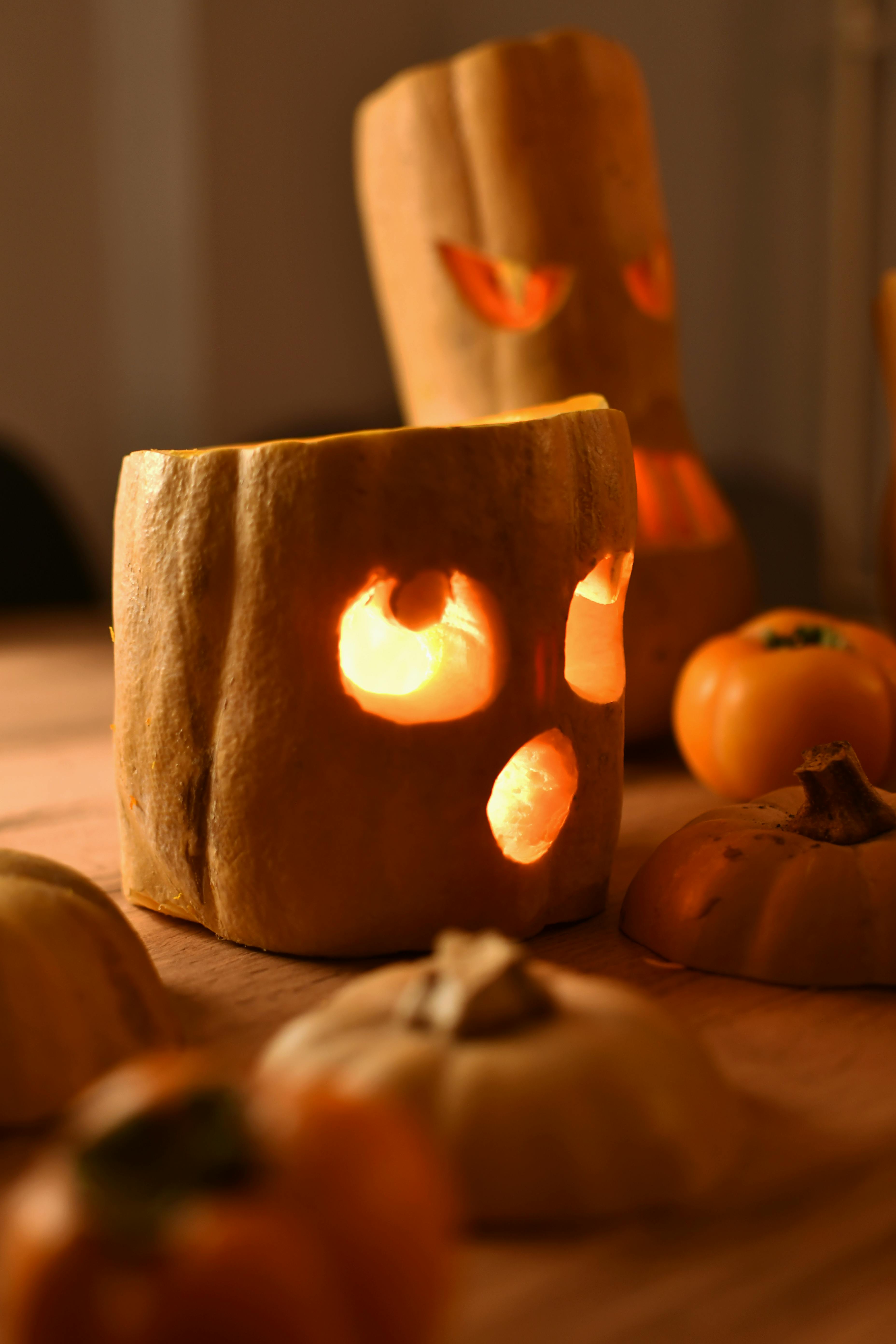 Carved pumpkin jack-o'-lanterns casting spooky shadows, creating a Halloween ambiance.