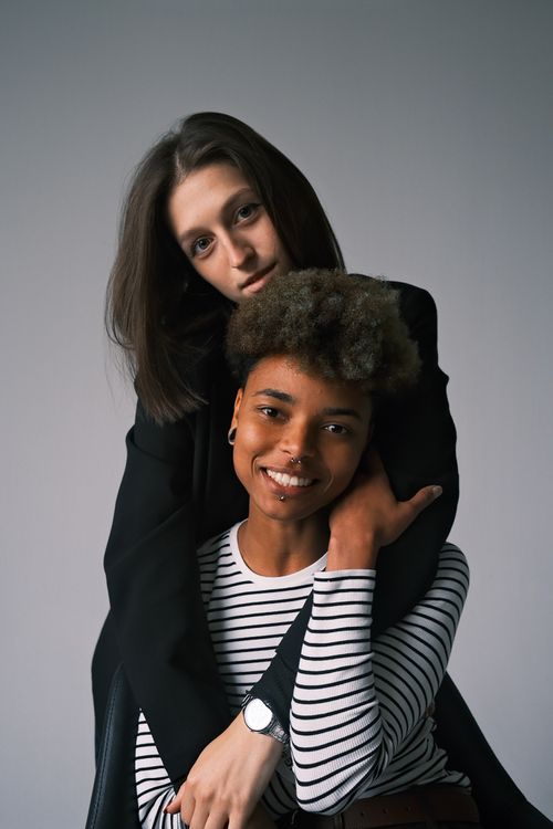 Free Heartwarming portrait of a close friendship between two young adults embracing. Stock Photo