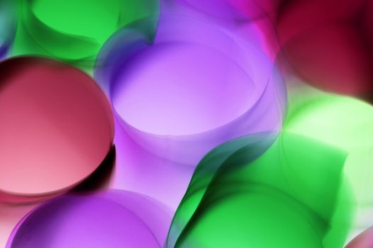Vibrant abstract image featuring colorful overlapping circles with dominant green, purple, and red hues.