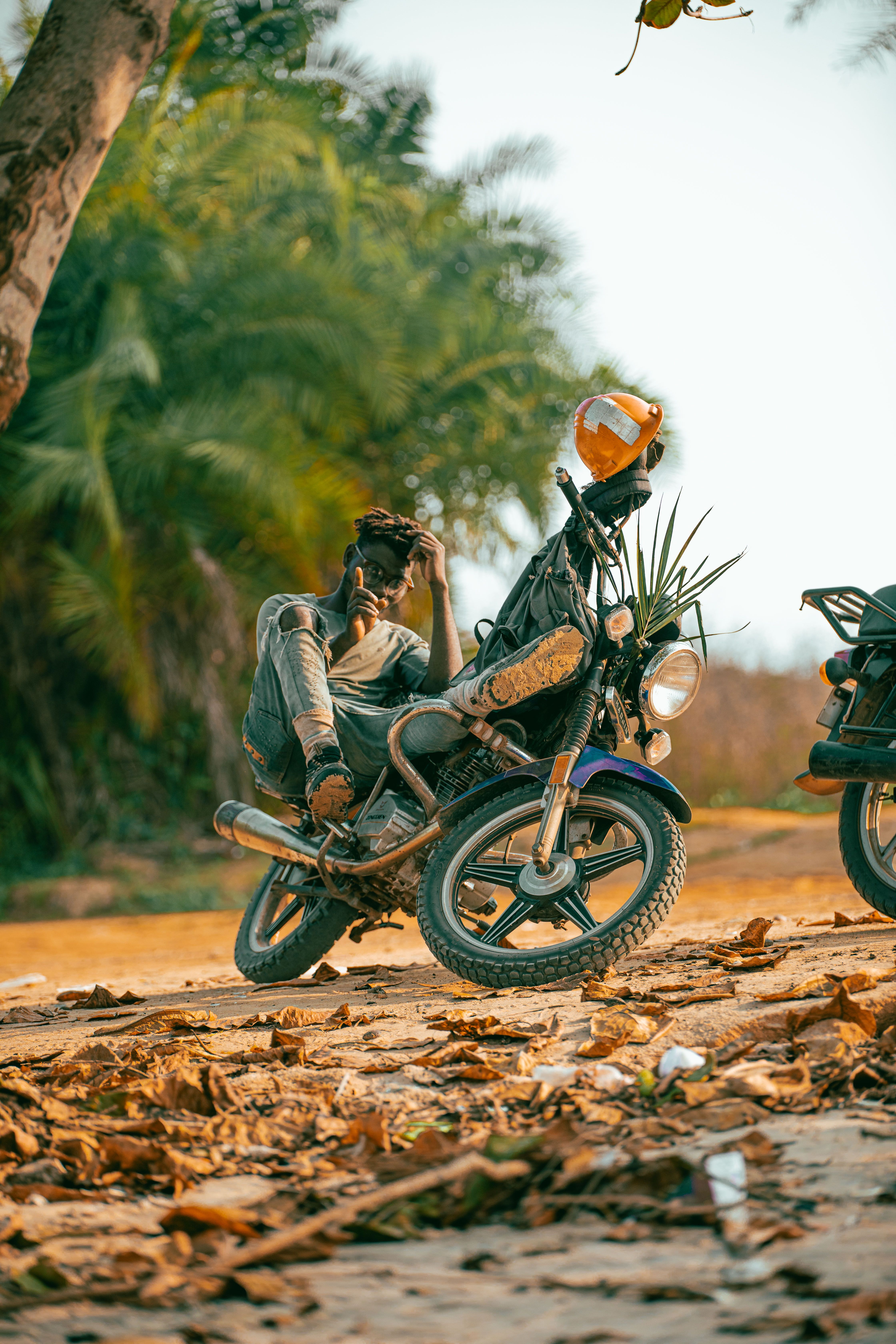 Casual Motorcycle Rider Relaxing Outdoors · Free Stock Photo