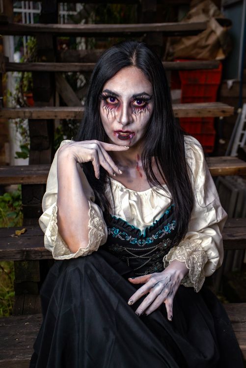 Vampire Woman in Gothic Costume on Wooden Stairs  Free Stock Photo