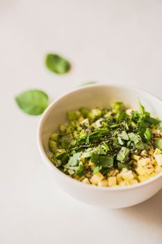 Healthy salad bowl with avocados, spinach and fresh herbs. Perfect for a nutritious meal.