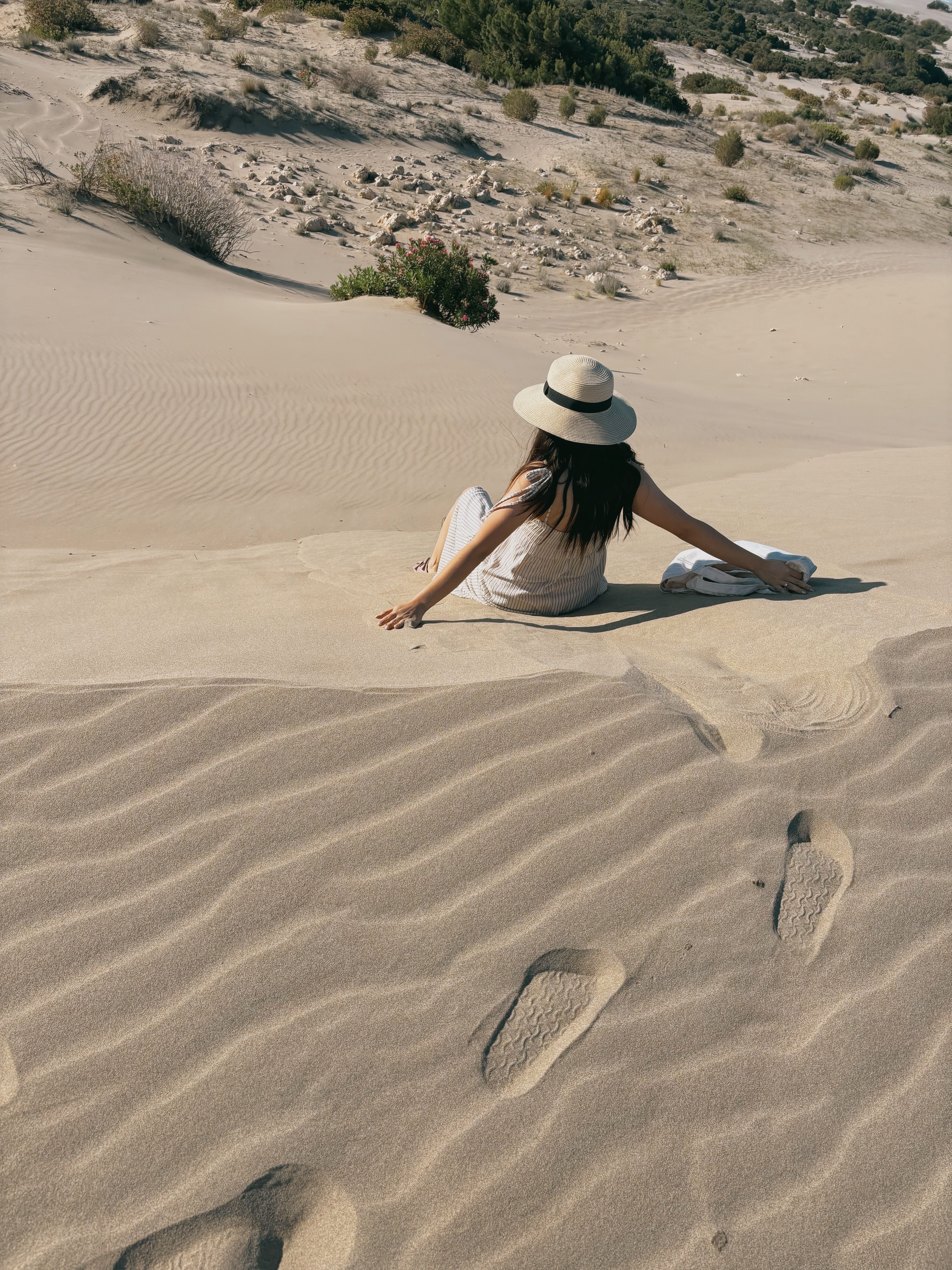 Woman Relaxing on Serene Desert Sand Dune · Free Stock Photo