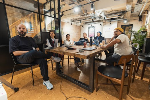 Diverse team engaged in a collaborative meeting in a contemporary office space.