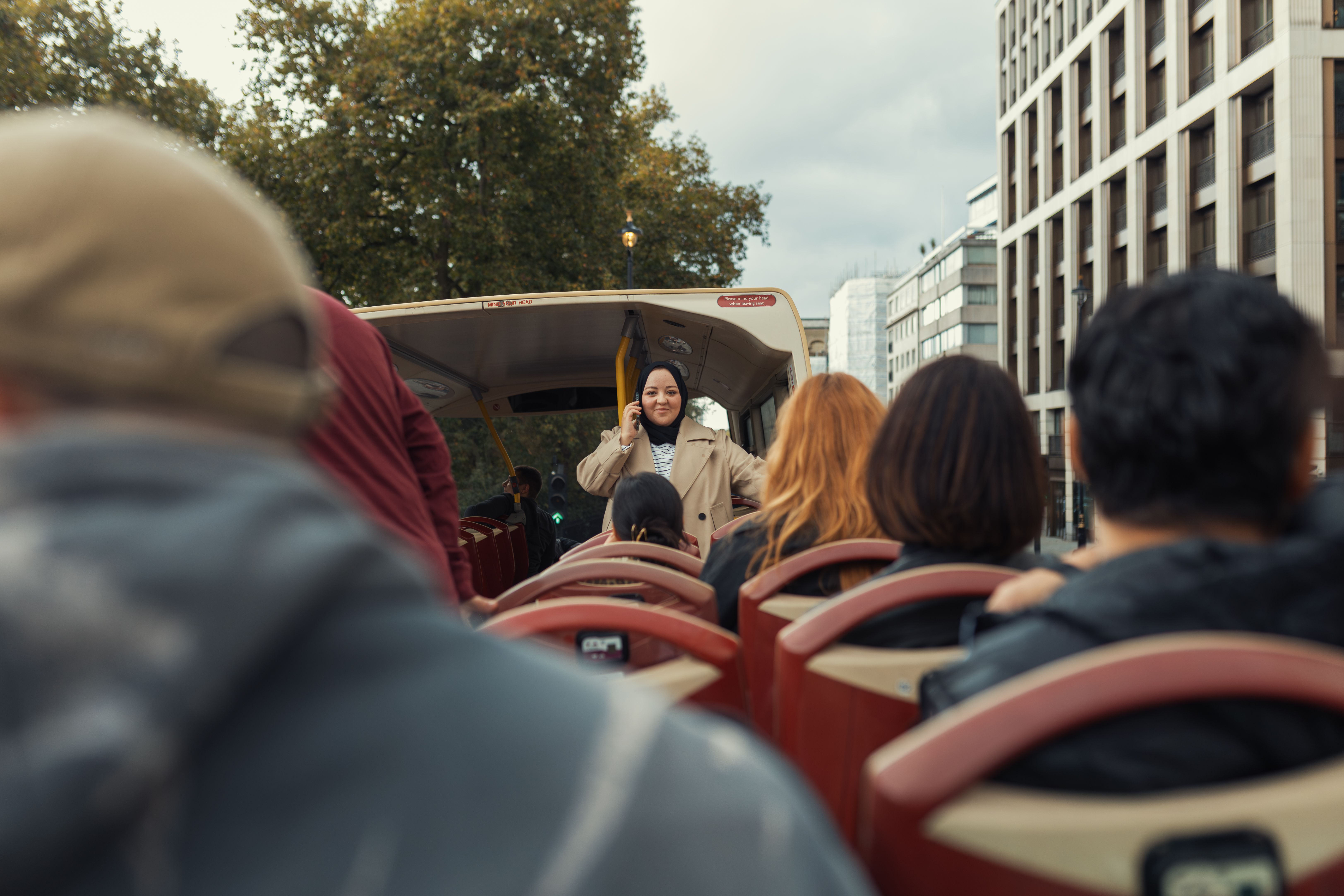 Tourists Enjoy Sightseeing Bus Ride in Urban Setting · Free Stock Photo