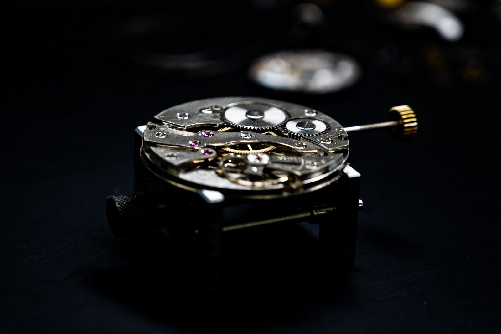 Macro of a watch movement on a dark background