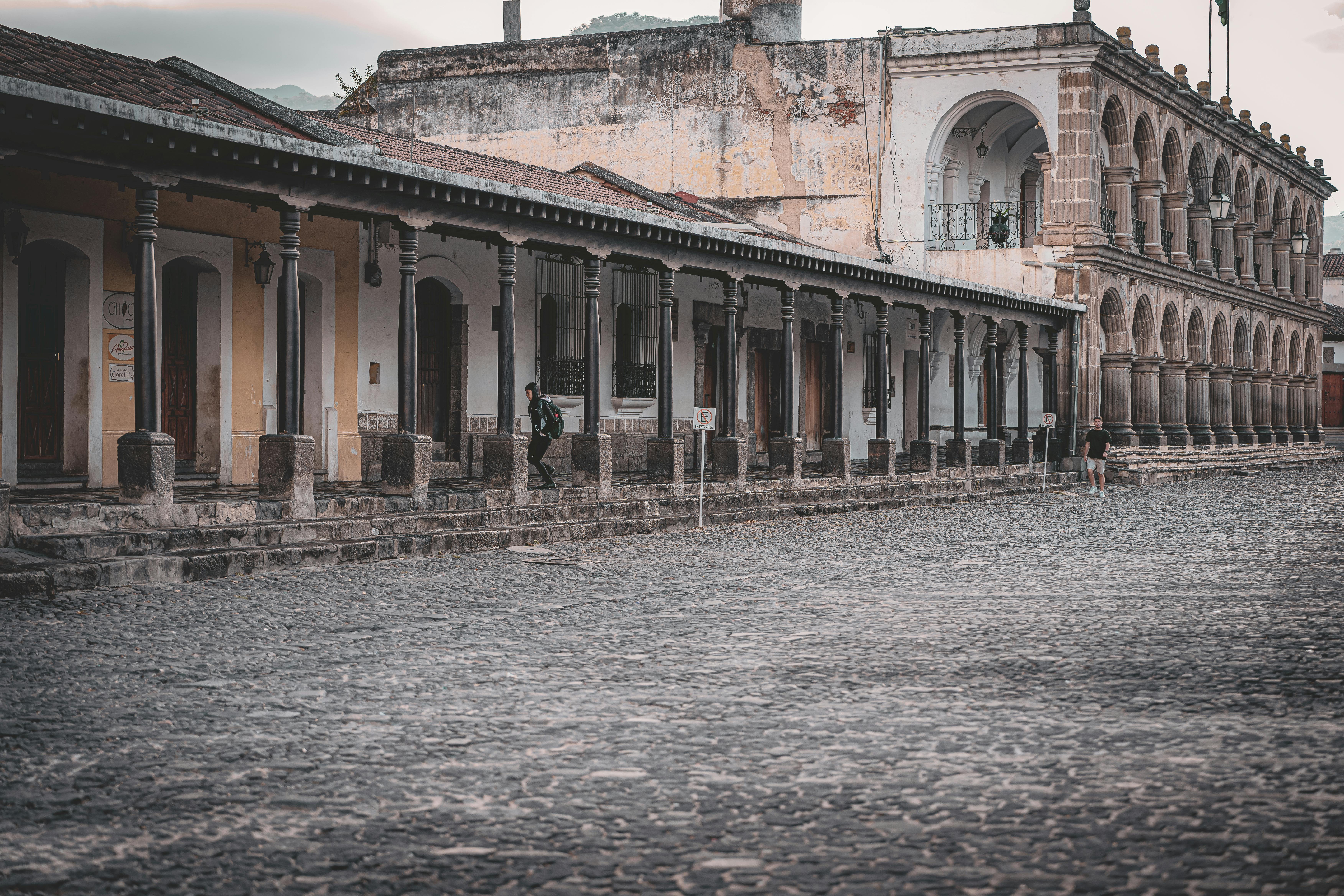 Mobile data for tourists in Antigua Guatemala — colonial buildings with stone archways and cobblestone streets