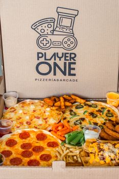 Pizza and appetizers in a gamer-themed box from Player One PizzeríaBarcade.