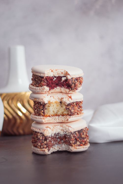 Free Delicious gourmet macarons stacked elegantly, coated with nuts and rich fillings. Stock Photo