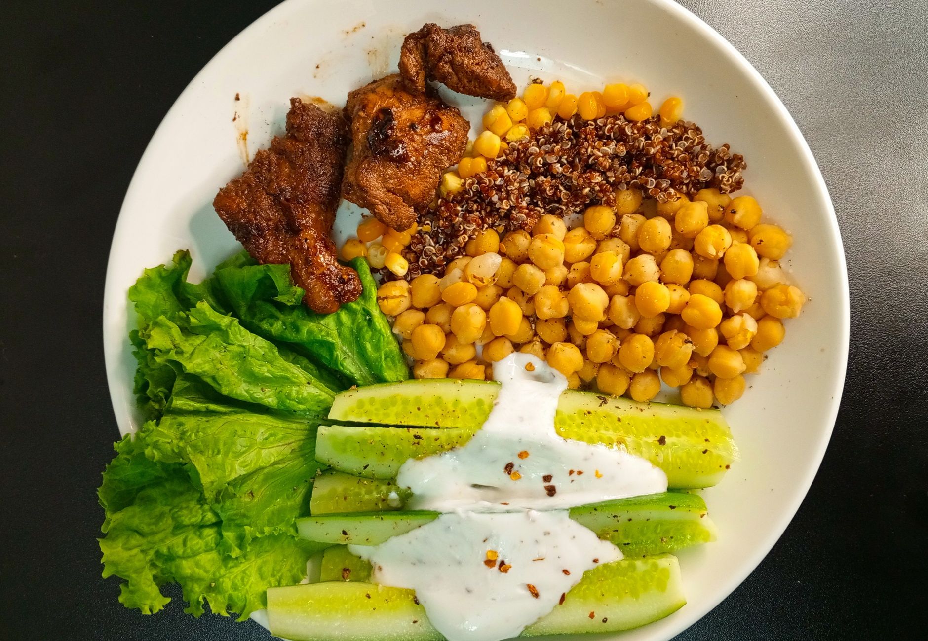 A nutritious bowl with quinoa, chickpeas, and fresh vegetables, perfect for a healthy meal.