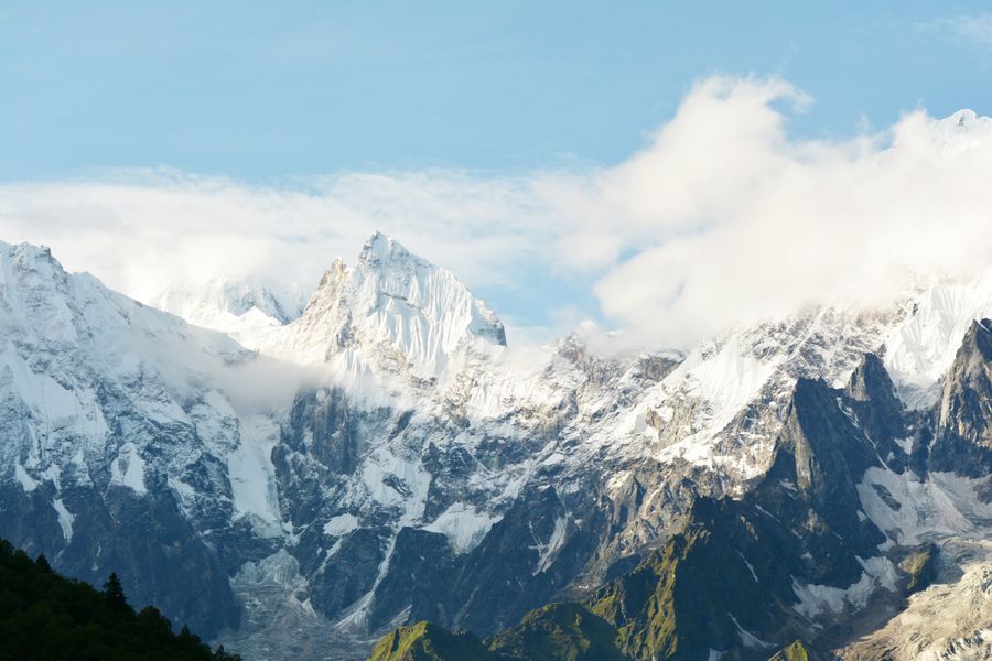 Breathtaking view of the snow-capped Manaslu mountains in Nepal under a clear sky.