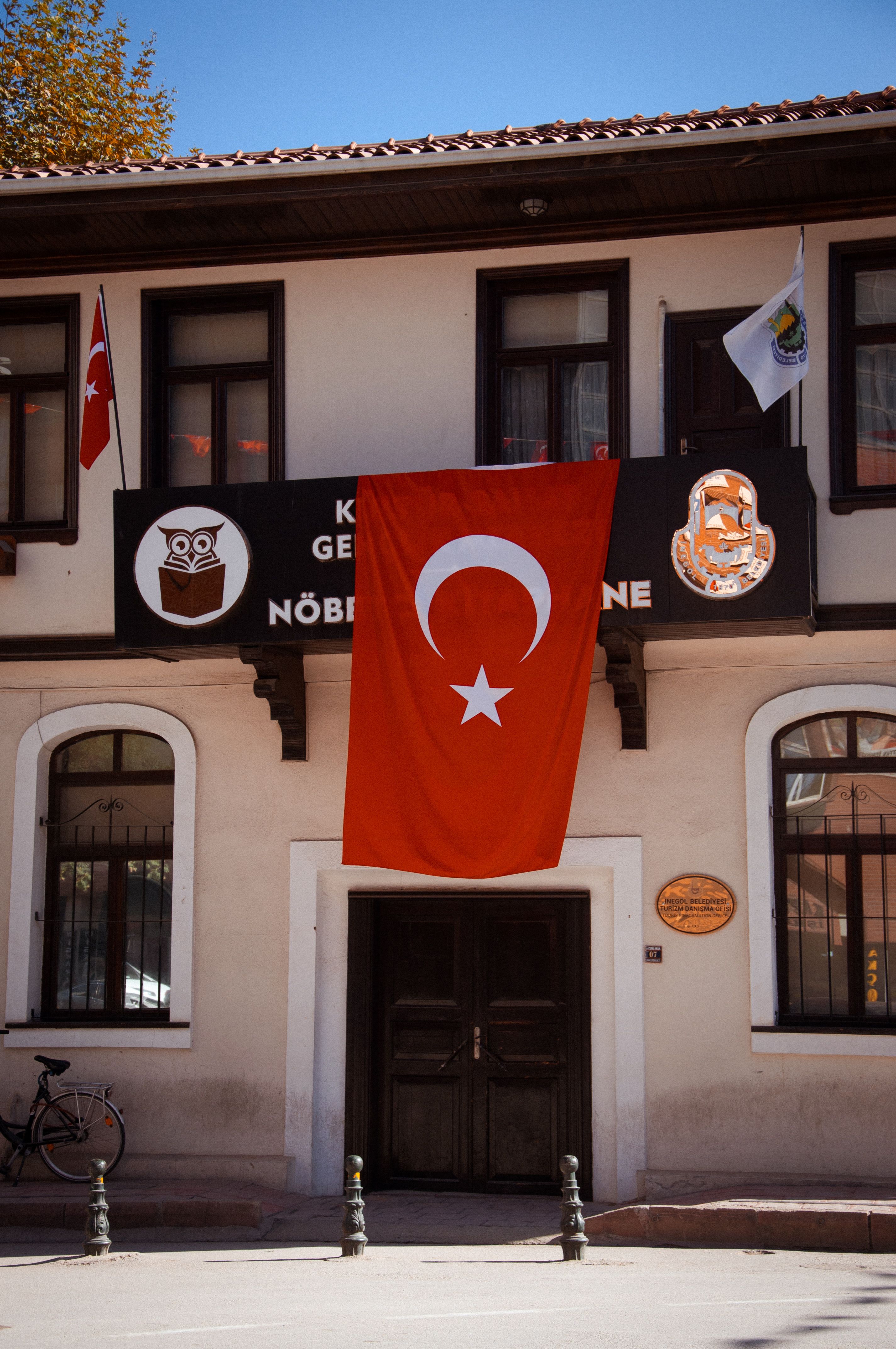 A historic building with the Turkish flag on display, showcasing national pride.